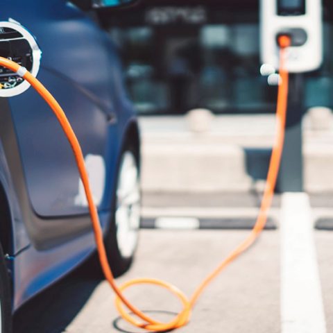 An electric vehicle charging at a public charge point